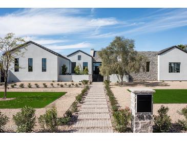 Stunning single Gathering home featuring xeriscaping, natural stone, and green lawn at 9810 N 57Th St, Paradise Valley, AZ 85253