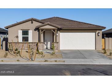Single-story home with a two-car garage and desert landscaping at 22526 W Tonopah Dr, Surprise, AZ 85387