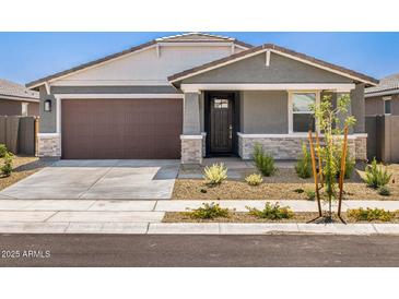 Charming single-story home featuring a two-car garage and well-maintained xeriscaped front yard at 20331 N 225Th Dr, Surprise, AZ 85387