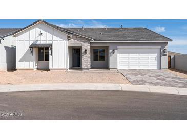 Charming single-story home featuring a modern design with stone accents and a two-car garage at 4780 W Flat Iron Ct, Queen Creek, AZ 85144