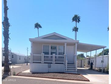 Charming single-story home with a covered carport and manicured landscaping in a sunny, vibrant community at 7300 N 51St Ave # F 99, Glendale, AZ 85301