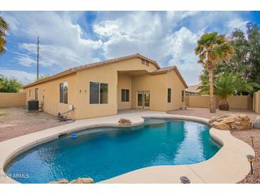 Inviting backyard with a sparkling pool, lush landscaping, and a private outdoor space perfect for entertaining at 2156 E Aloe Pl, Chandler, AZ 85286