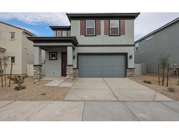 Two-story house with gray siding, brown accents, and a two-car garage at 2646 E Bluff Spring Ave, Apache Junction, AZ 85119