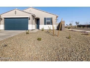 Newly built home with desert landscaping and a two-car garage at 16006 W Cottontail Ln, Surprise, AZ 85387