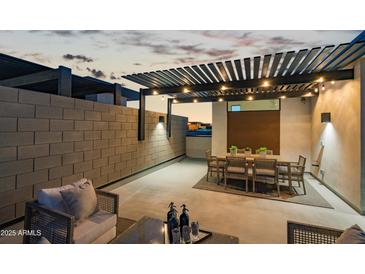 An elegant outdoor patio featuring dining and seating areas under a stylish pergola, perfect for evening entertainment at 377 E Windsor Ave # 21, Phoenix, AZ 85004