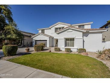 Two story house with a landscaped lawn and a two car garage at 718 E Scorpio Pl, Chandler, AZ 85249
