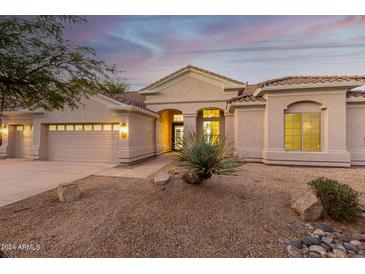 Beautiful desert home with stucco exterior, neutral color palette, and mature landscaping at 11568 E Whispering Wind Dr, Scottsdale, AZ 85255