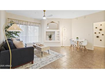 Inviting living room featuring a ceiling fan, neutral tones and cozy seating arrangement at 10401 N Saguaro Blvd # 224, Fountain Hills, AZ 85268