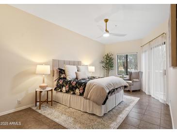 Comfortable bedroom with neutral walls, ceiling fan, decorative lamps, and a plush area rug at 10401 N Saguaro Blvd # 224, Fountain Hills, AZ 85268