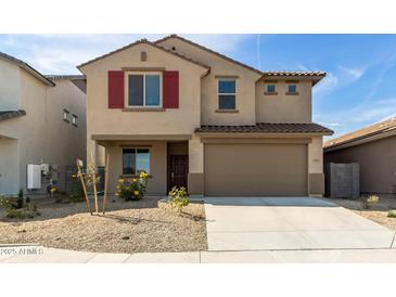 Two-story home featuring red shutters and a two car garage with desert landscaping at 8552 N 170Th Ln, Waddell, AZ 85355