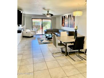 Spacious living room with large sectional sofa and sliding glass doors at 272 Leisure World --, Mesa, AZ 85206