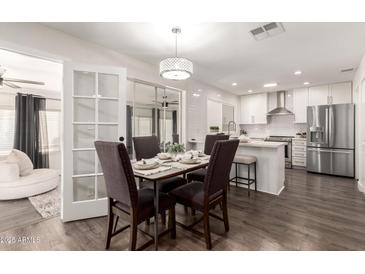 Modern kitchen with white cabinetry, stainless steel appliances, and breakfast bar at 1315 E Gemini Dr, Tempe, AZ 85283