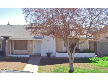 Tan single story home with a white door and mature tree at 4147 W Reade Ave, Phoenix, AZ 85019