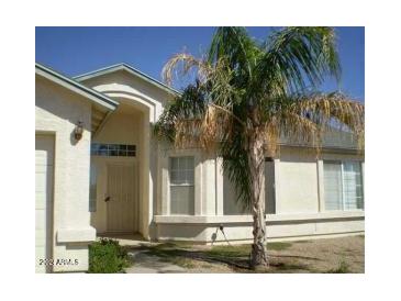 One-story house with light-colored exterior and palm tree at 8464 W Royal Blackheath Dr, Arizona City, AZ 85123