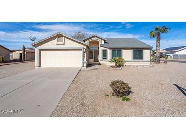 Charming single-story home featuring a two car garage and desert landscaping at 8464 W Royal Blackheath Dr, Arizona City, AZ 85123