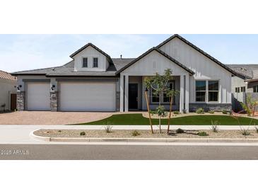 Beautiful two-story home with a manicured lawn and a three-car garage at 1042 W Ridge Rd, Apache Junction, AZ 85120