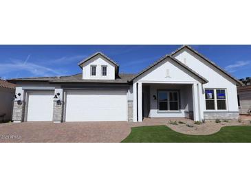 Charming single-story home with a three-car garage and well-manicured landscaping at 1042 W Ridge Rd, Apache Junction, AZ 85120