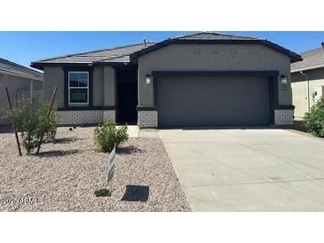 Charming single-story home with a two-car garage and low-maintenance desert landscaping at 38155 W Excussare Way, Maricopa, AZ 85138