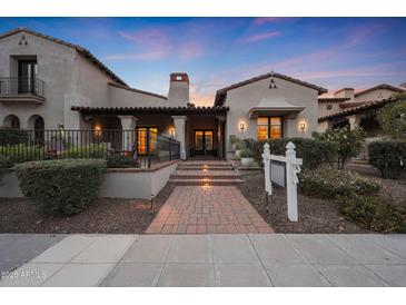 Stunning Spanish-style home with brick pathway and lush landscaping at 19992 N 101St Pl, Scottsdale, AZ 85255