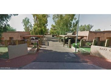 Exterior view of apartment building with covered parking and landscaping at 2333 W Glenrosa Ave # 105, Phoenix, AZ 85015