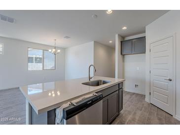 Modern kitchen with gray cabinets, white quartz countertops, and stainless steel appliances at 40000 W Bunker Dr, Maricopa, AZ 85138