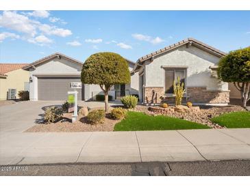 Single-story home with landscaped front yard, two-car garage, and attractive curb appeal at 27078 W Yukon Dr, Buckeye, AZ 85396