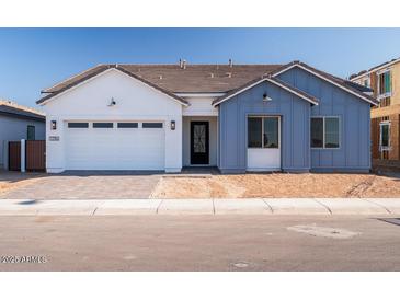 Charming single-Gathering home with a two-car garage, manicured lawn, and inviting front entrance at 1296 E Coconino Way, Gilbert, AZ 85298