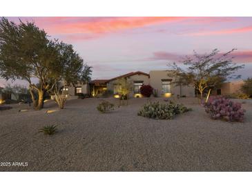 Beautiful single-story home with desert landscaping and a tile roof at dusk at 7928 E Parkview Ln, Scottsdale, AZ 85255