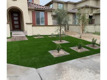 Well-manicured lawn and landscape design enhance the curb appeal of this beautiful, two-story home at 5819 N 88Th Ln, Glendale, AZ 85305