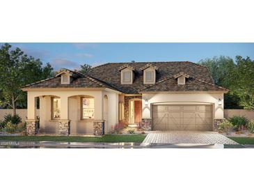 One-story home with a two-car garage, stone accents, and a charming front yard at 2533 E Russell St, Mesa, AZ 85213