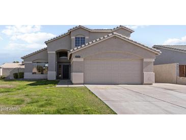 Two-story house with attached garage and well-maintained lawn at 1207 N Velero St, Chandler, AZ 85225