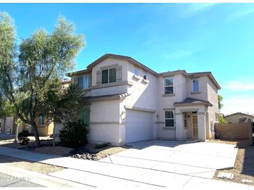 Two-story house with attached garage and landscaped front yard at 17323 W Woodlands Ave, Goodyear, AZ 85338