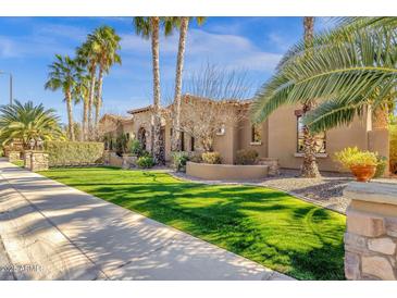 Beautiful desert home with lush landscaping, sidewalk and verdant green lawn at 4301 E Taurus Pl, Chandler, AZ 85249