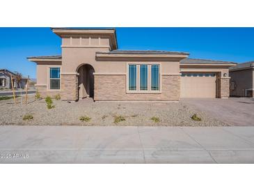 Single-story home with stone accents and a two-car garage at 19026 W Ocotillo Rd, Waddell, AZ 85355