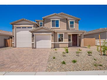Charming two-story home with a three-car garage, desert landscaping, and a brick paver driveway at 18746 E Panchito Dr, Gold Canyon, AZ 85118