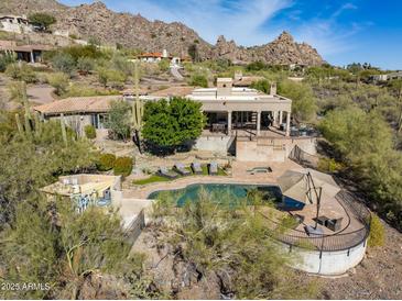 Stunning property featuring a large pool and expansive patio at 6527 E El Sendero Rd, Carefree, AZ 85377