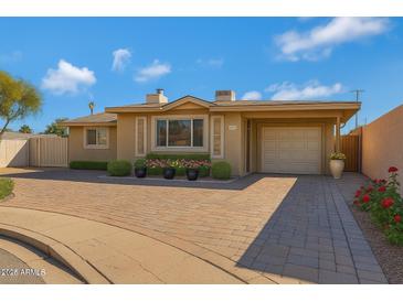 Charming single-story home featuring a brick driveway, manicured landscaping, and a one-car garage at 1859 N Morris --, Mesa, AZ 85201