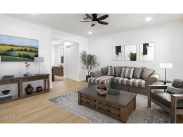 Bright living room features a comfy sofa and stylish coffee table at 749 W Southgate Ave, Phoenix, AZ 85041