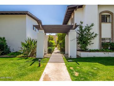 Inviting front gate and walkway leading to the property, with manicured lawn and landscaping at 3637 E Monterosa St # 17, Phoenix, AZ 85018