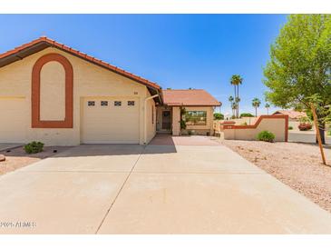 Charming single-story home with a well-maintained lawn and a two-car garage in a quiet neighborhood at 542 S Higley Rd # 99, Mesa, AZ 85206