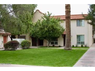 Charming two-story home featuring well-maintained landscaping and a red tile roof at 8241 N Central Ave # 24, Phoenix, AZ 85020