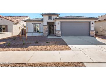 One-story home with stone accents and two-car garage at 17831 W Encinas Ln, Goodyear, AZ 85338