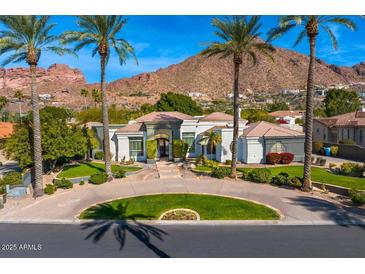 Luxury home with circular driveway, mountain views, and lush landscaping at 5112 E Pasadena Ave, Phoenix, AZ 85018