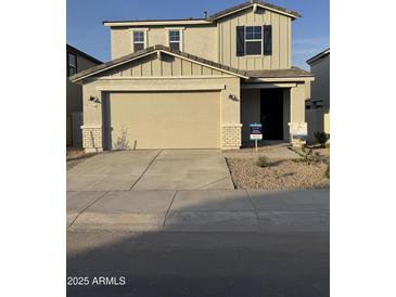 Two-story home with attached garage and landscaped front yard at 2594 E Bluff Spring Ave, Apache Junction, AZ 85119