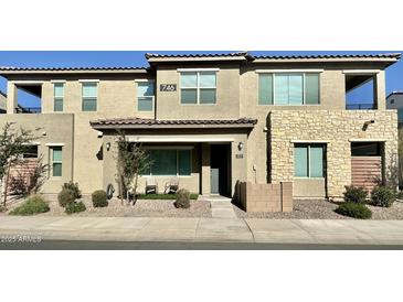 Two-story townhome with stone accents and a landscaped front yard at 746 E Doral Ave # 201, Gilbert, AZ 85297