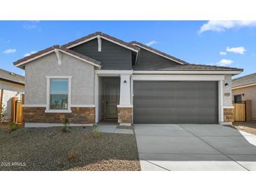 Charming single-story home with a two-car garage and stylish stone accents on the facade at 16555 N Lunar St, Maricopa, AZ 85138