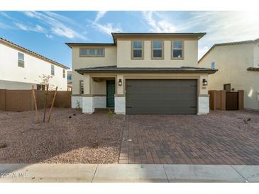 Charming two-story home with a two car garage and well-maintained landscaping and brick driveway at 11612 W Beck Dr, Youngtown, AZ 85363