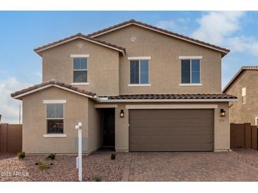 Charming two-story home with a desert landscape, brown stucco, and a large two car garage at 9042 N 116Th Ln, Youngtown, AZ 85363
