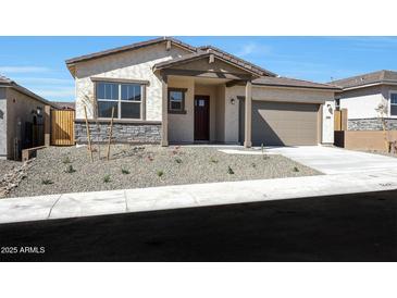 Charming single-story home featuring a desert landscaped yard and a covered front porch at 28266 N 134Th Dr, Peoria, AZ 85383