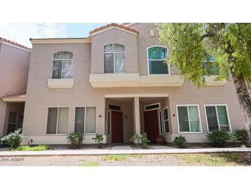 Charming townhome with neutral paint, stylish windows, and front yard landscaping at 500 N Roosevelt Ave # 92, Chandler, AZ 85226